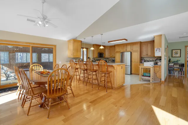 a living room with furniture a bookshelf and a window