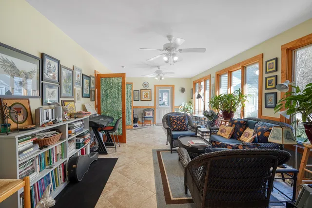 a view of a dining room with furniture a chandelier and wooden floor