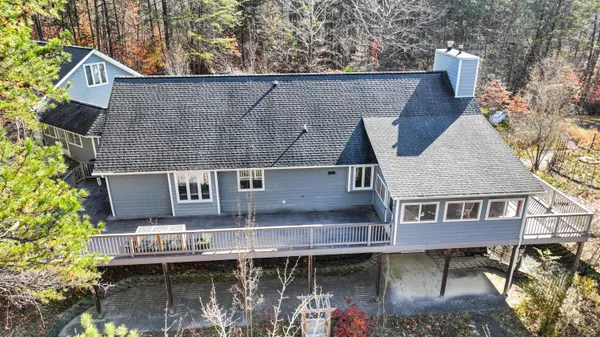 an aerial view of houses covered in trees