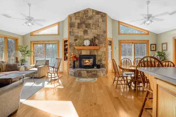a living room with fireplace furniture and a large window
