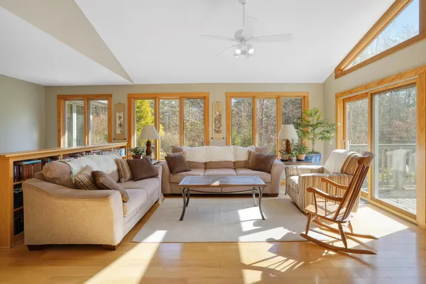 a kitchen with stainless steel appliances a sink a stove a refrigerator cabinets and a window