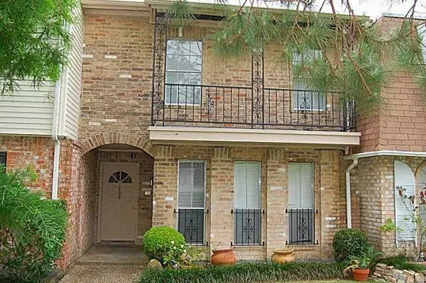 front view of a brick house with a large windows