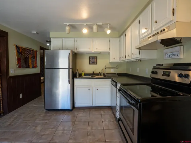 a kitchen with a refrigerator a stove a microwave and cabinets