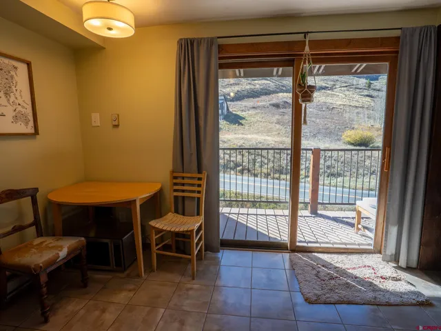 a view of a room with furniture and a window