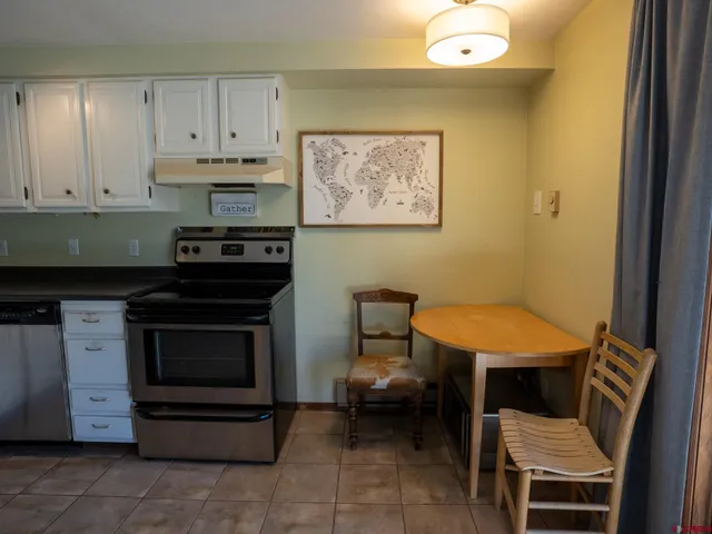 a kitchen with a stove and a refrigerator