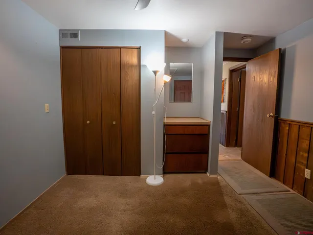 an empty room with closet and a bathroom