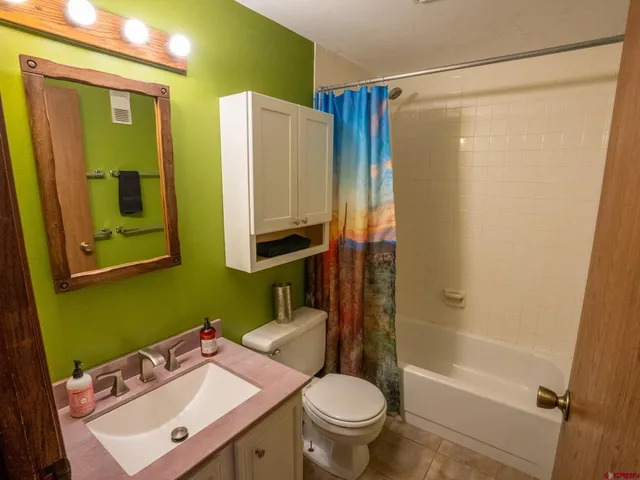 a bathroom with a sink mirror toilet and shower