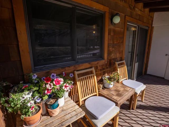 a outdoor dining space with furniture and flowers