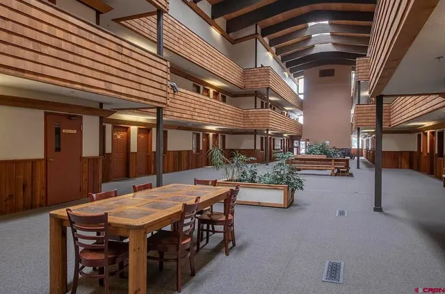 a view of a patio with a table and chairs and potted plants