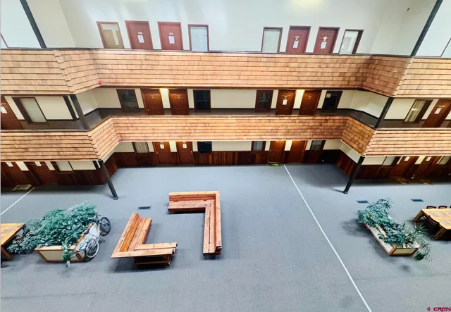 a view of a couches and table in the balcony