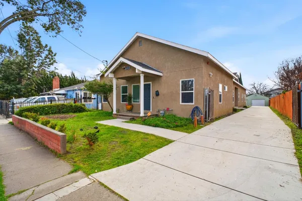 a front view of house with yard and green space