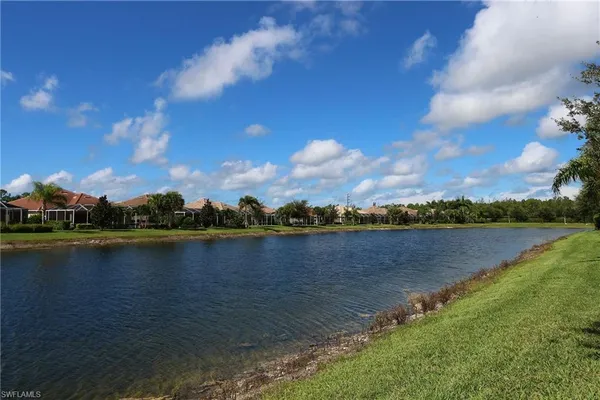 a view of a lake with houses in the back