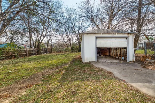 a white house that has tree in front of it