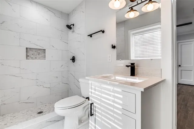 a bathroom with a sink toilet and shower