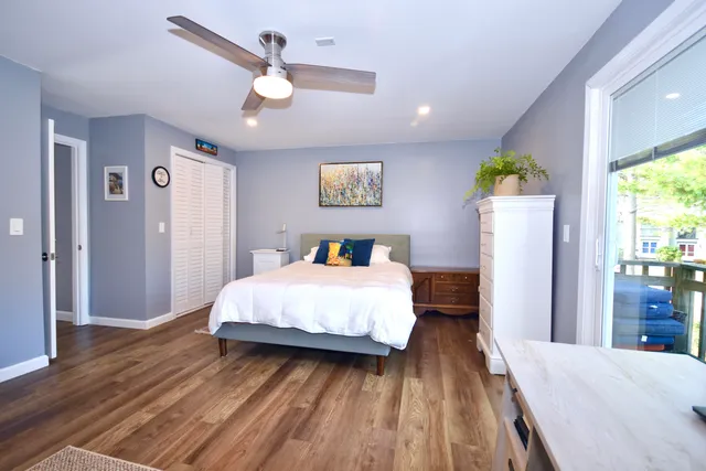 a spacious bedroom with a bed and a chandelier