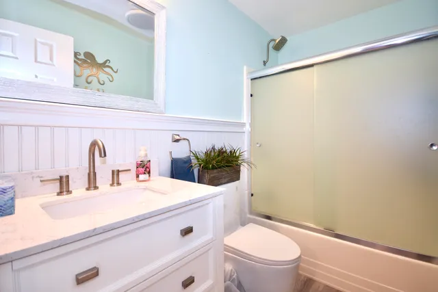 a bathroom with a sink a mirror and a toilet