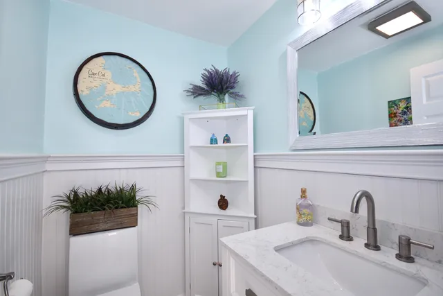 a bathroom with a sink a mirror and a window