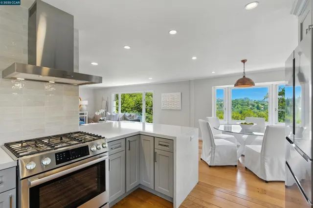 a kitchen with a stove a sink and a wooden floor