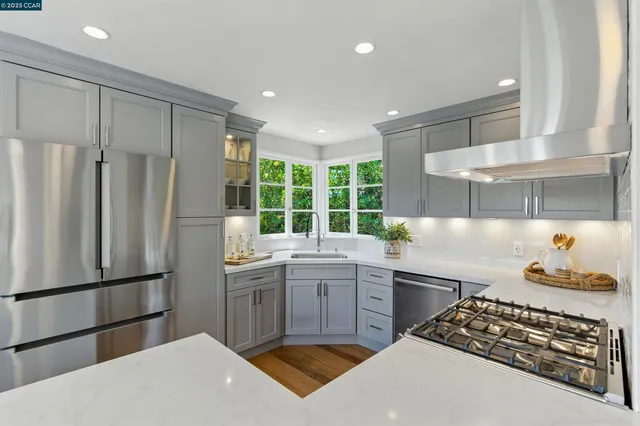 a kitchen with a stove a refrigerator and a sink