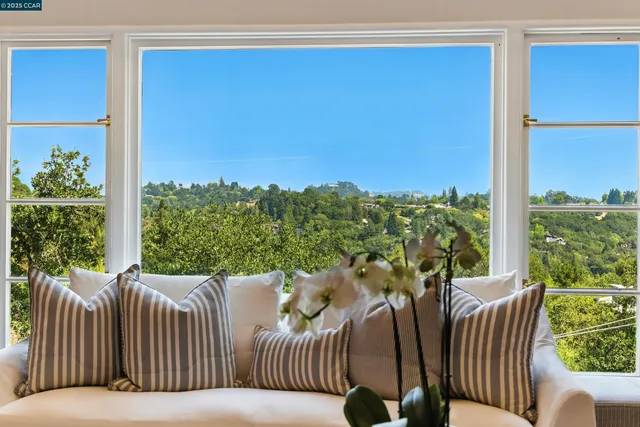 a balcony with furniture and a garden
