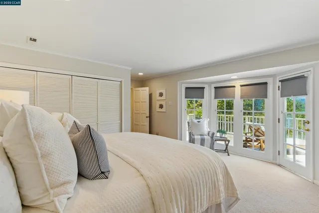 a spacious bedroom with a bed and wooden floor