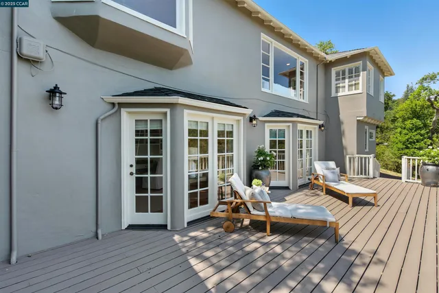 a view of a house with backyard porch and sitting area