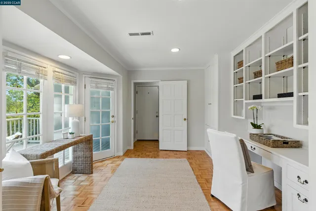 a living room with furniture a flat screen tv and large window