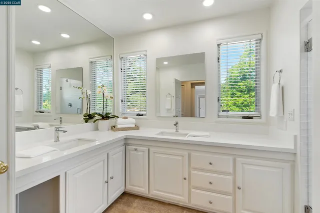 a bathroom with double sink and a mirror