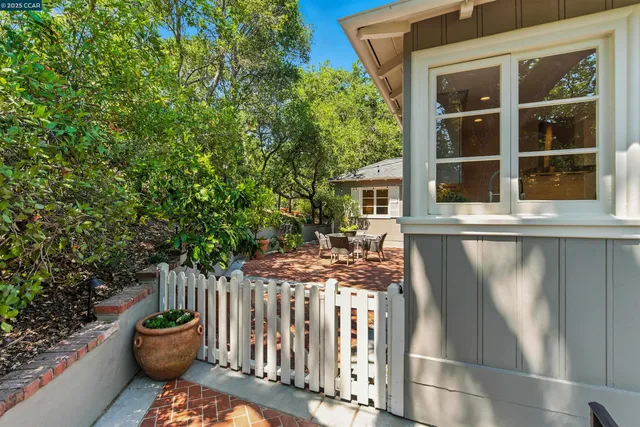 a view of a chair and table in the backyard