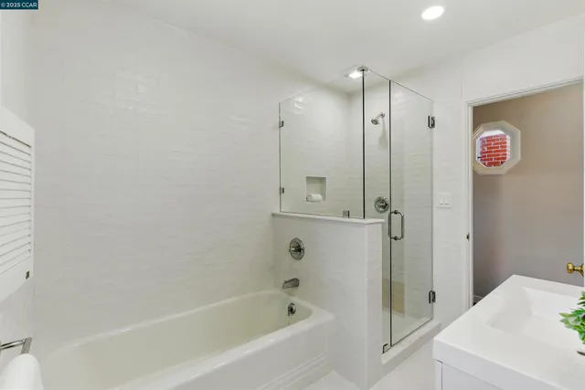 a bathroom with a bathtub and a shower