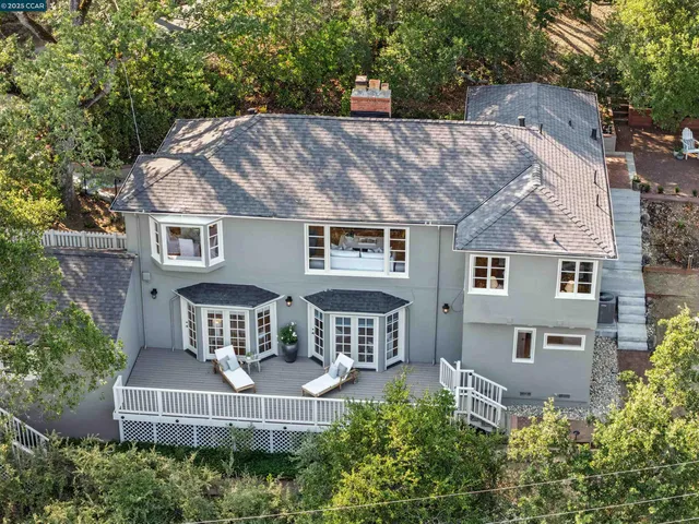 an aerial view of a house with table and chairs