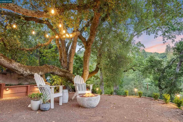 a view of balcony with furniture and trees