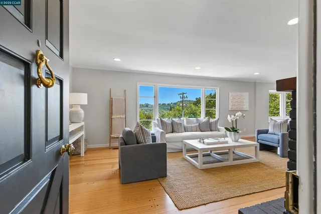 a living room with furniture large window and a flat screen tv