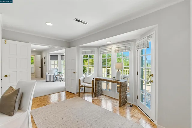 a living room with furniture and a floor to ceiling window