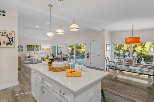 a view of a kitchen with dining table and chairs