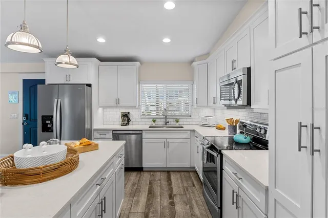 a kitchen with a sink stove and refrigerator