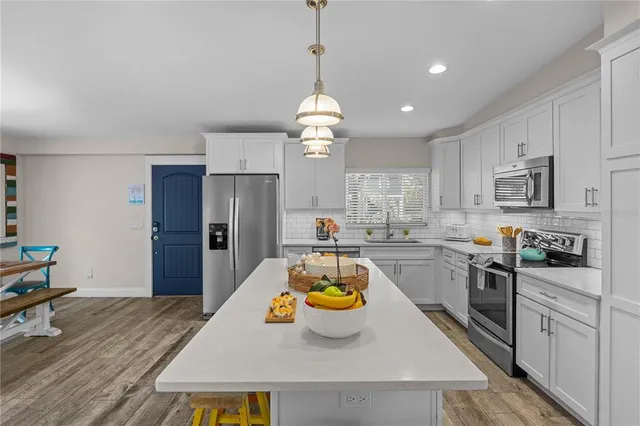a kitchen with sink refrigerator and stove
