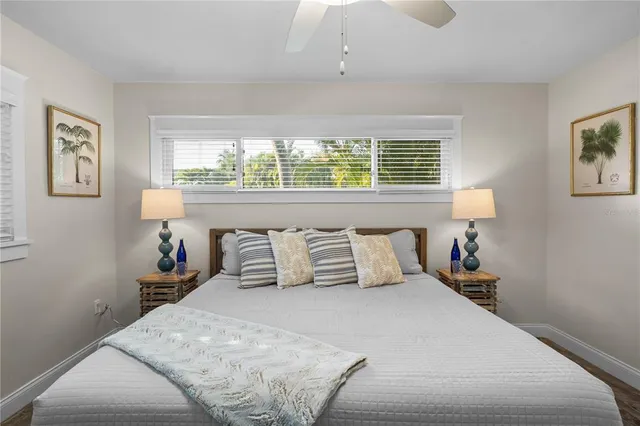 a bedroom with a large bed and a window