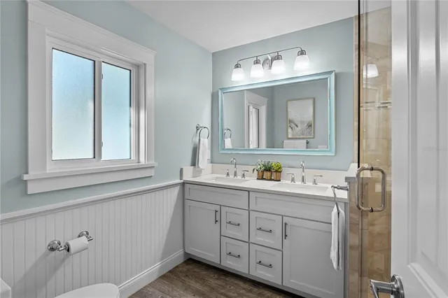 a bathroom with a window sink and mirror