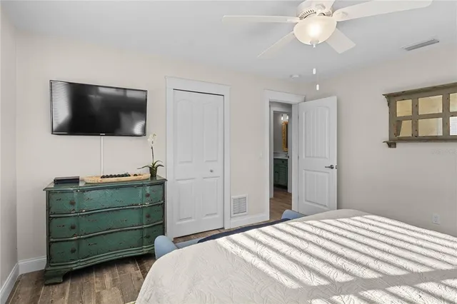 a bedroom with a bed and flat screen tv