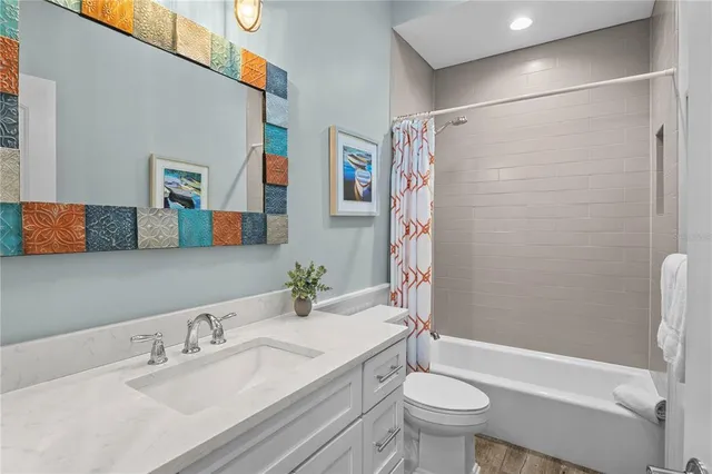 a bathroom with a granite countertop toilet sink and shower