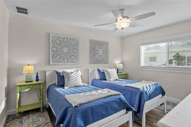 a bedroom with a bed a chandelier and a window