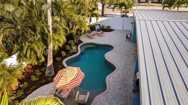 a view of swimming pool with a backyard and seating area