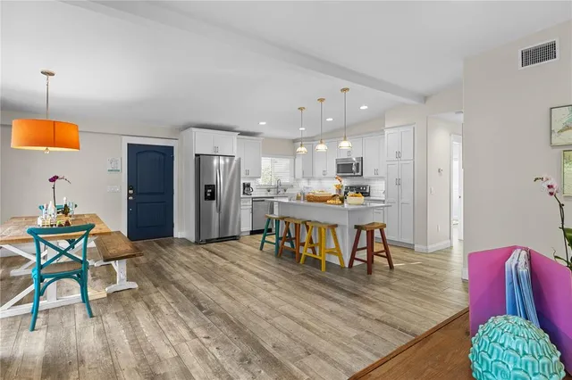 a view of a dining room with furniture and wooden floor