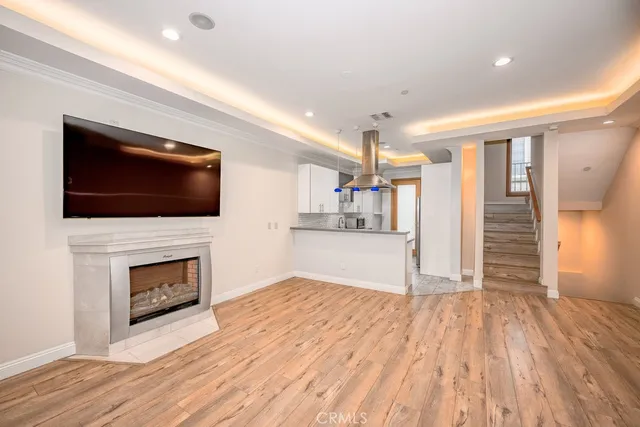 a view of empty room with wooden floor and fireplace
