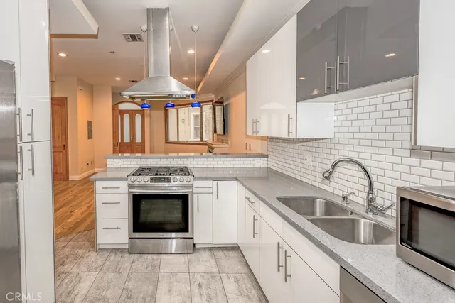 a kitchen with a sink cabinets stainless steel appliances and a counter top