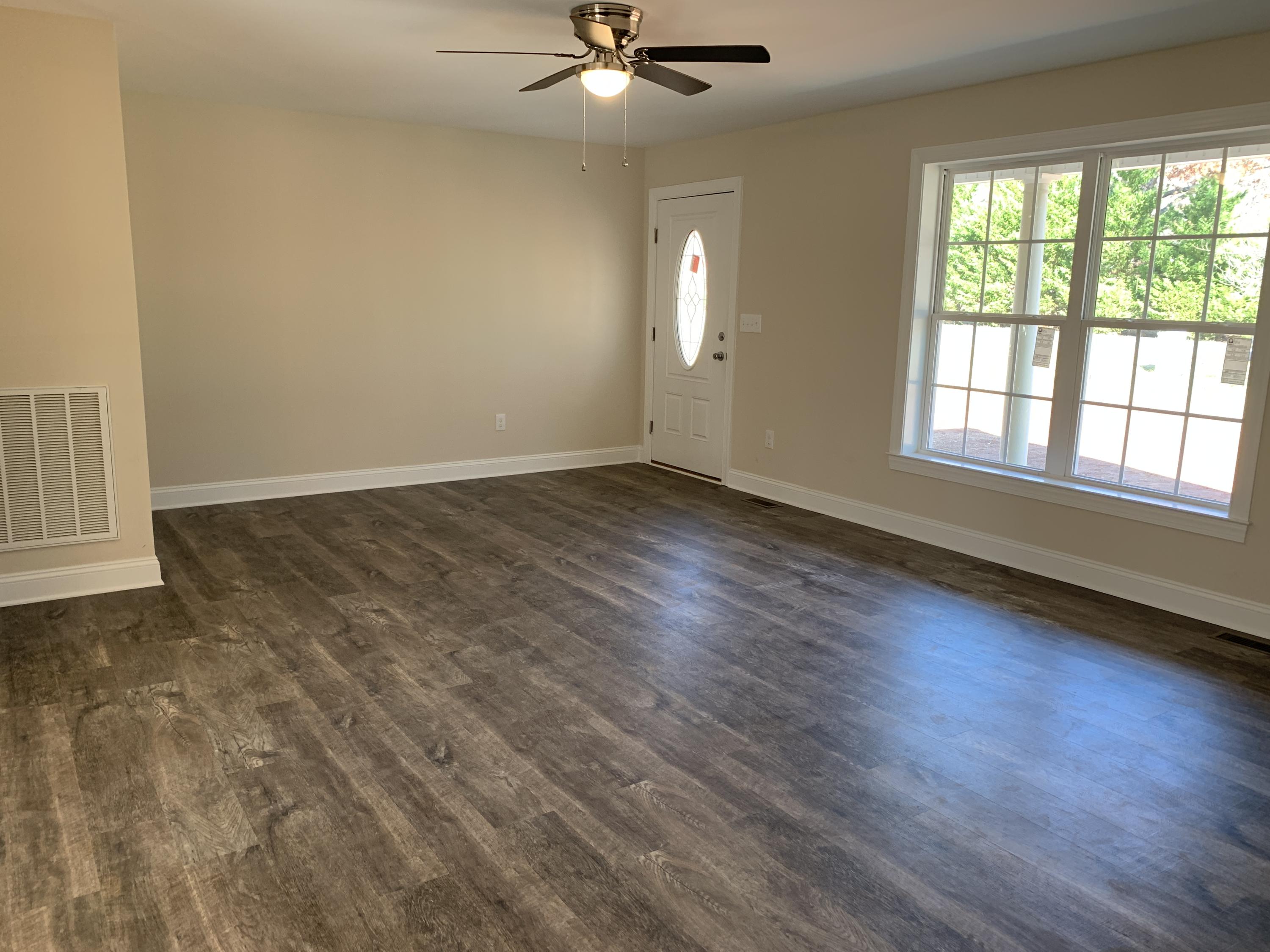 2731 Edwardsville Road Hardy, VA 24101 - Photo 2 of 45 an empty room with wooden floor fan and windows