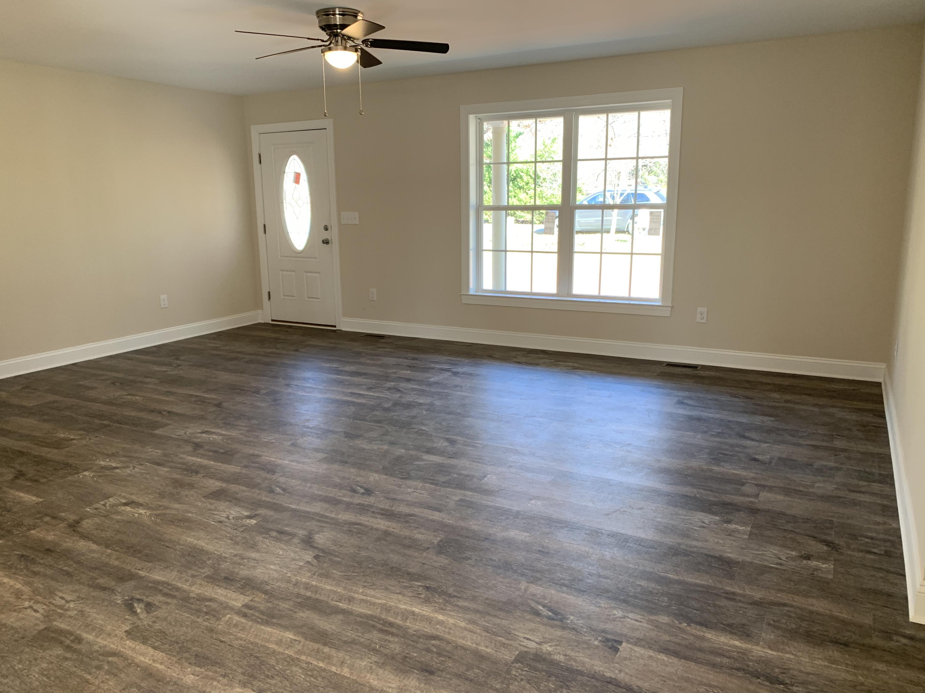 2731 Edwardsville Road Hardy, VA 24101 - Photo 23 of 45 an empty room with wooden floor fan and windows