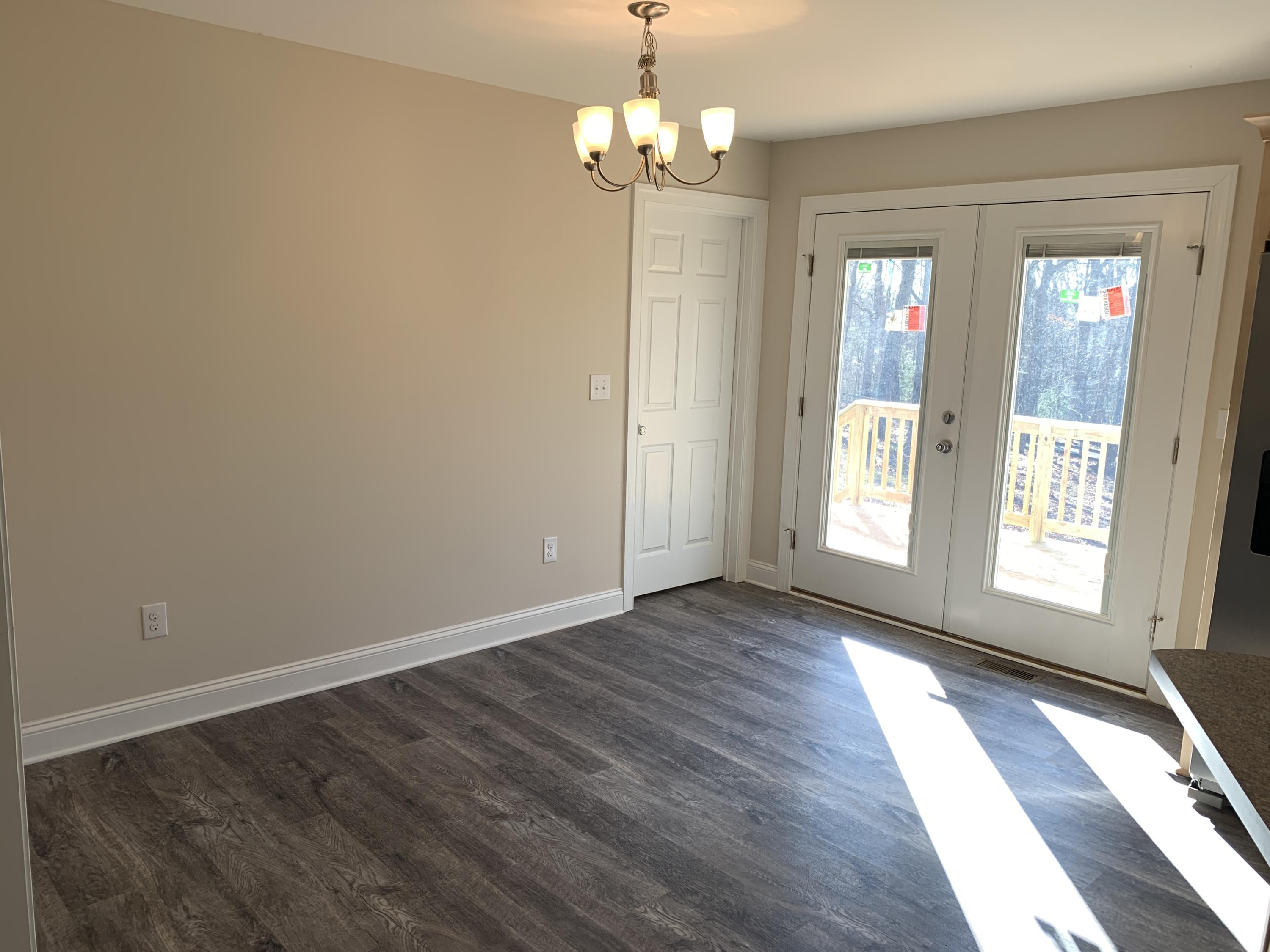 2731 Edwardsville Road Hardy, VA 24101 - Photo 5 of 45 a view of an empty room with wooden floor and a window