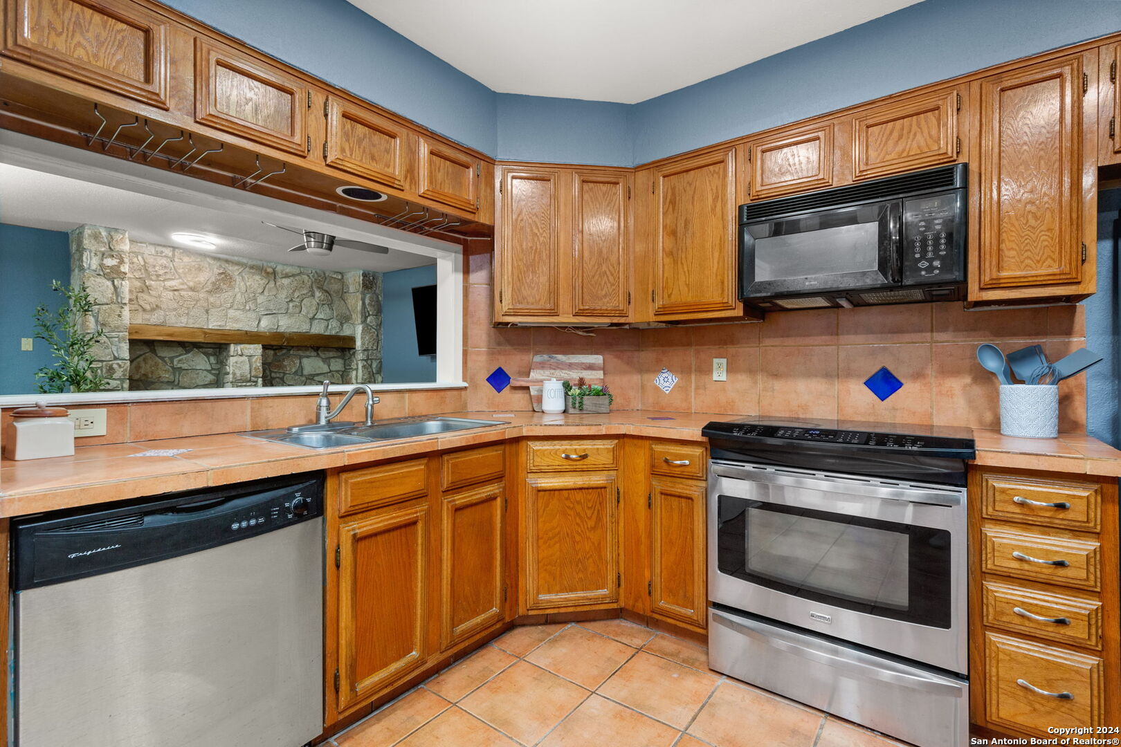 11520 Huebner Road, Unit 102 San Antonio, TX 78230 - Photo 4 of 15 a kitchen with stainless steel appliances granite countertop a stove microwave and sink